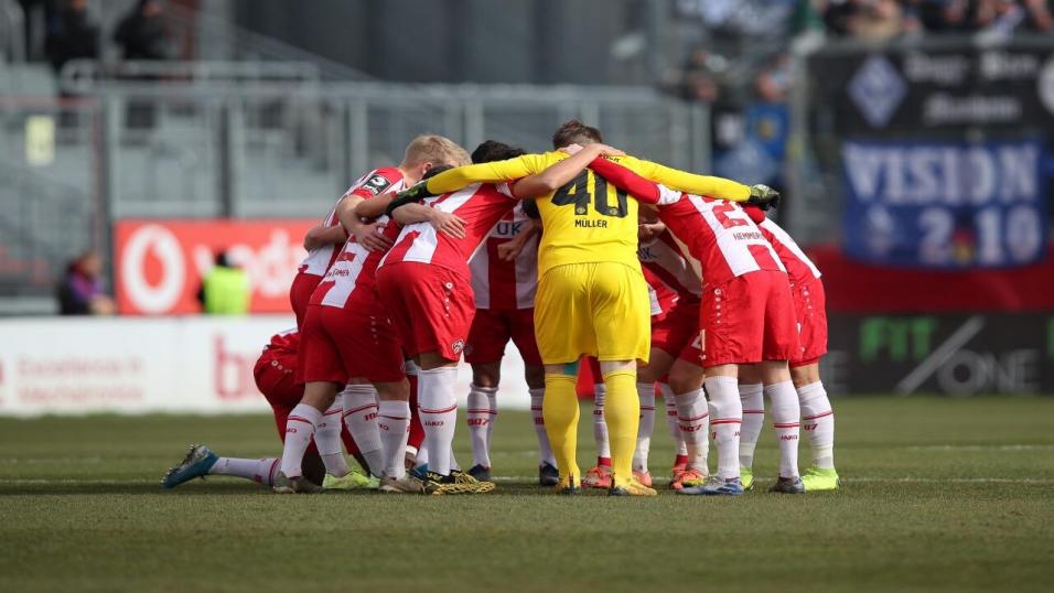 Wurzburger Kickers players in a pre-match huddle